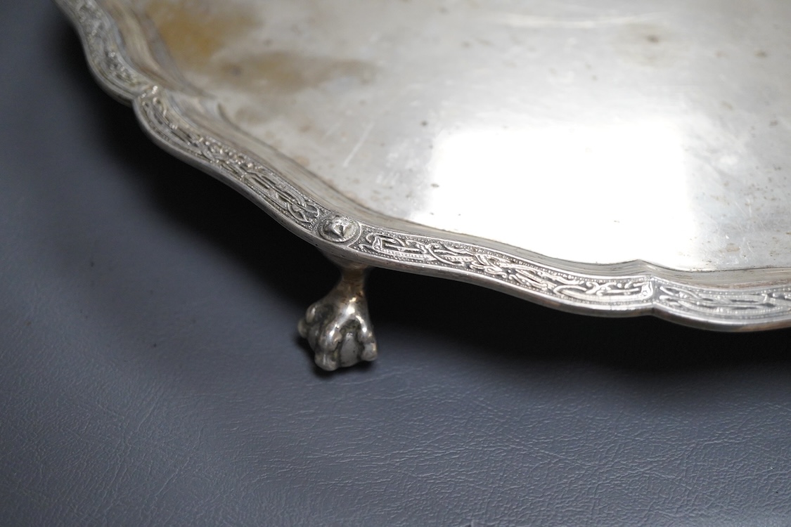 A George VI silver salver, of shaped circular form, on four claw and ball feet, with presentation inscription, Reid & Sons, London, 1936, 35.7cm, 40.5oz.